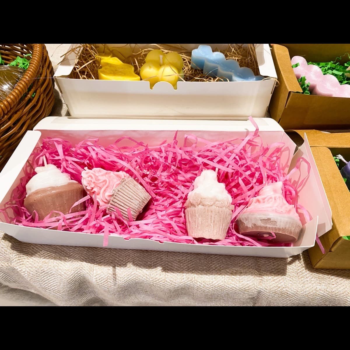 Pink cupcake and ice-cream candles in a white gift box with pink paper