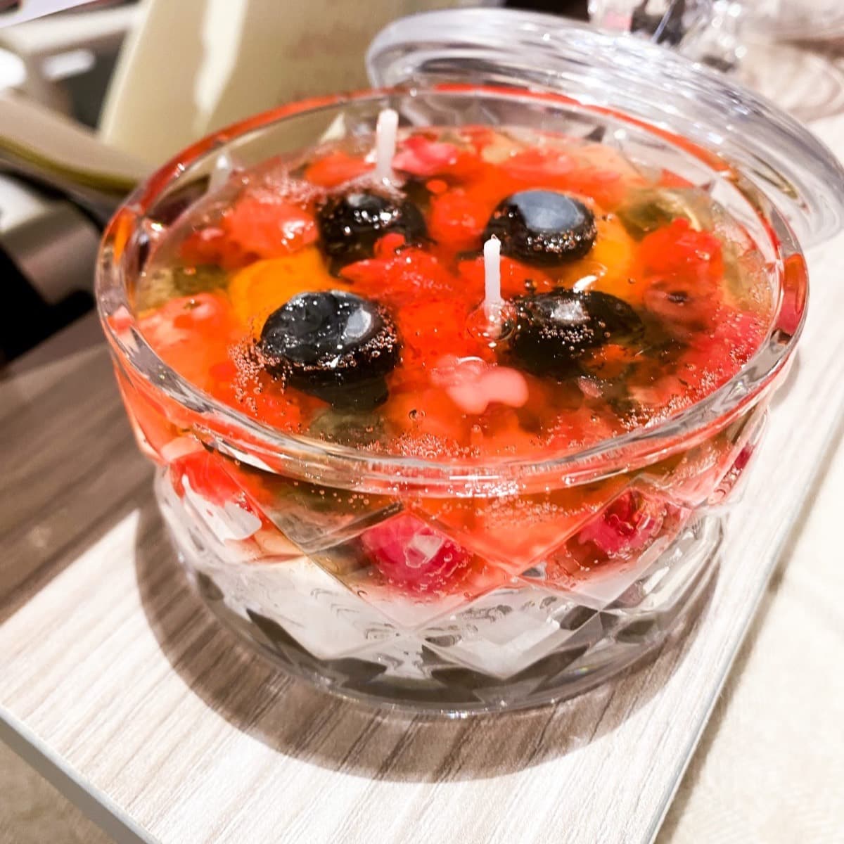 Berry trifle candle in a crystal bowl with lid — red and gold layers with wax berries