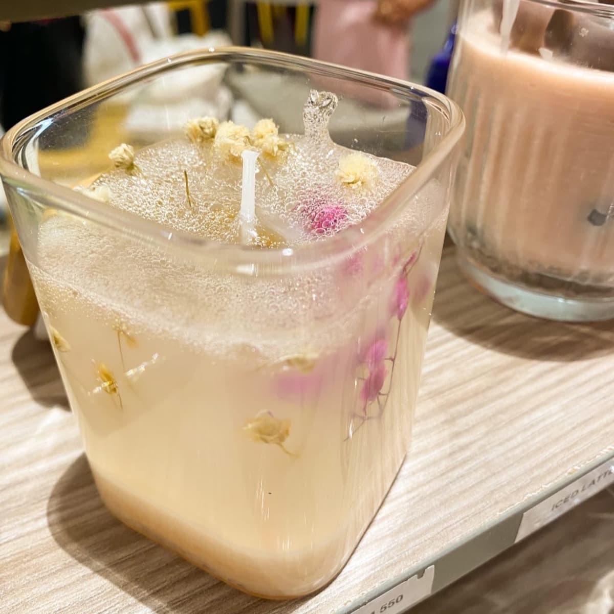 Blossom candle — clear wax holding real dried flowers in a square glass